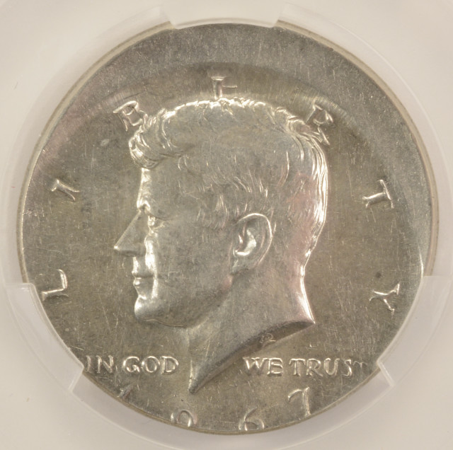 1967 Kennedy half dollar off-center strike mint error showing design shifted away from center with blank planchet edge visible